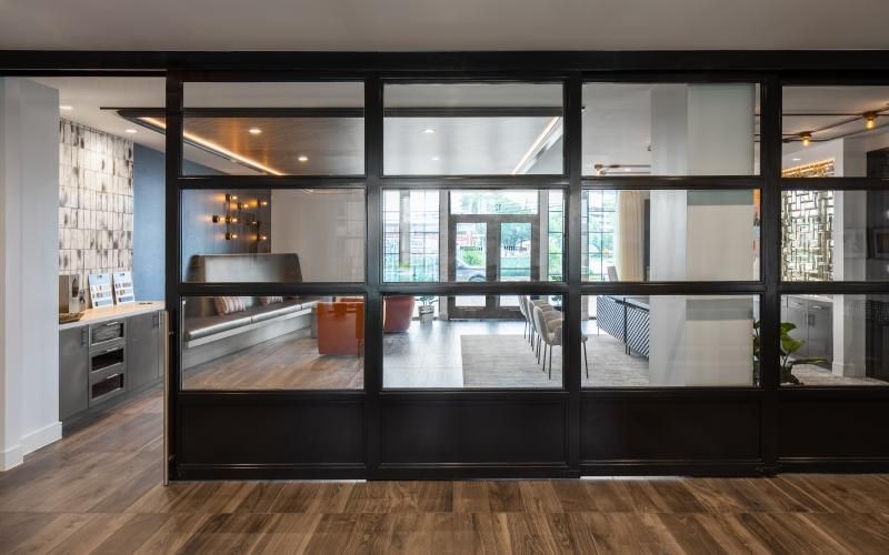 a work room with glass walls and a wood floor