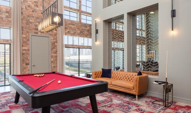 a lounge room with a pool table and a couch