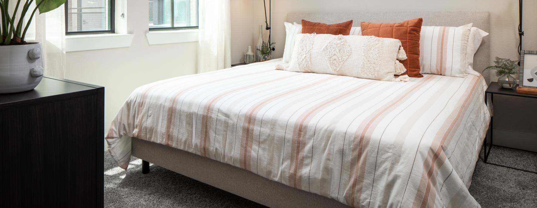 a bed in a bedroom with windows